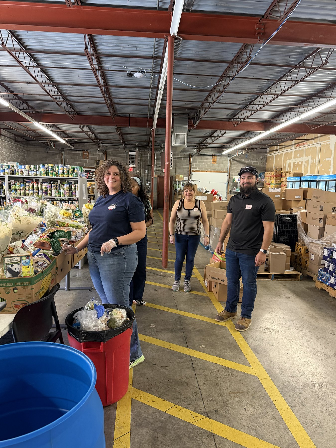 VISION volunteers organizing food inside the Loaves and Fishes pantry